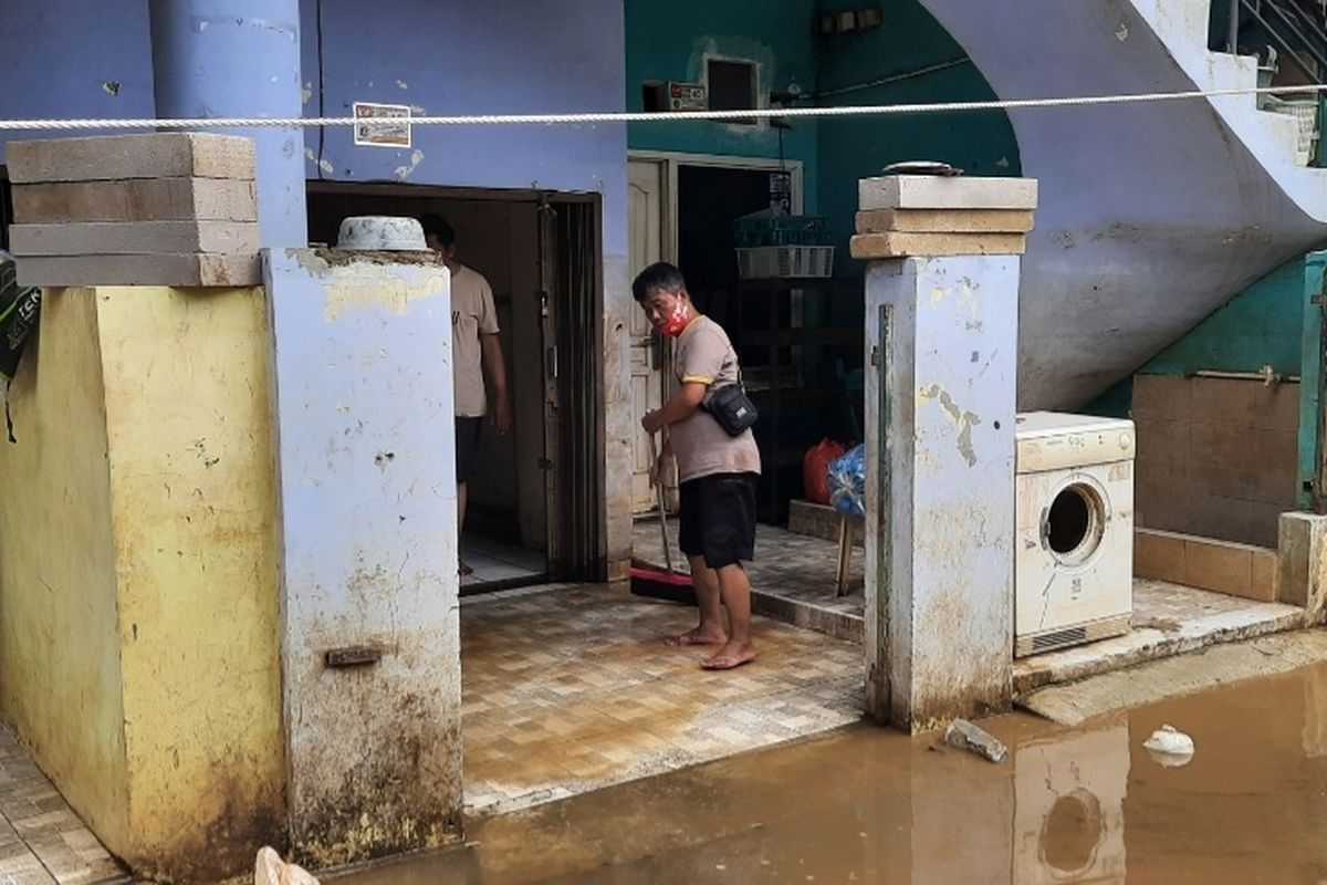 Warga Cipinang Melayu, Jakarta Timur, mulai membersihkan sisa-sisa banjir, Minggu (21/2/2021).