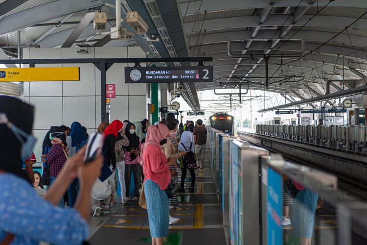 Pengguna jasa MRT Jakarta sedang menunggu ratangga di peron Stasiun Lebak Bulus Grab.