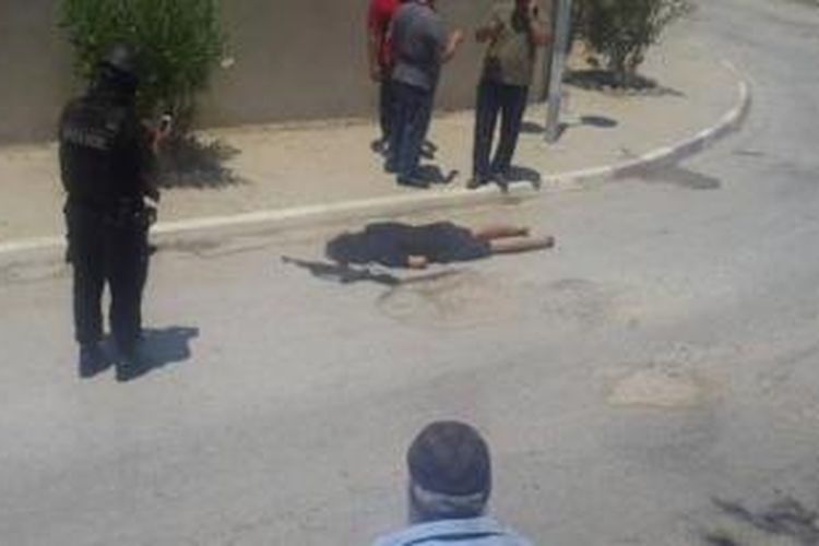 Dalam foto yang tersebar di media sosial ini terlihat tersangka pelaku penembakan di dua hotel di kota Sousse, Tunisia, Jumat (26/6/2015), tergeletak tak bernyawa di salah satu sudut jalan.