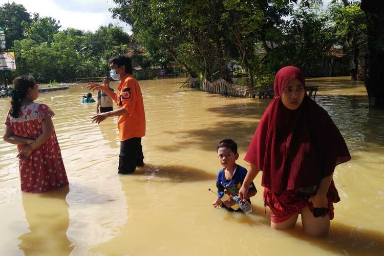 Petugas dari BPBD Pamekasan membagikan bantuan makanan ke warga yang terdampal banjir di Desa Sumedangan, Kecamatan Pademawu. Di Kecamatan Pademawu masih 2 desa yang belum surut yakni Desa Majungan dan Desa Sumedangan.