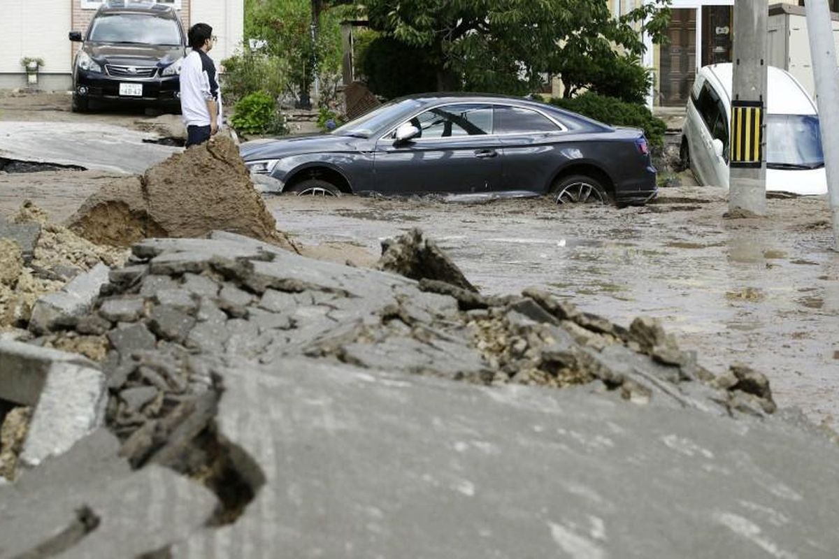 Mobil yang rusak akibat terdampak bencana gempa bumi yang melanda Hokkaido, Jepang.