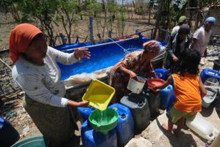 Warga Dusun Tengah, Desa Larangan Tokol, Kecamatan Tlanakan, bergembira saat menerima bantuan air dari Aliansi Jurnalis Pamekasan (AJP), Ahad (2/11/2014). 