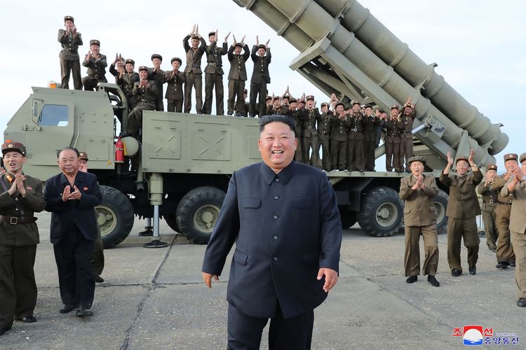 Gambar yang diambil pada 24 Agustus 2019 dan dirilis 25 Agustus oleh kantor berita Korea Utara 9KCNA) memperlihatkan Pemimpin Korut kim Jong Un merayakan uji coba senjata peluncur roket berukuran besar di lokasi yang tidak diketahui.