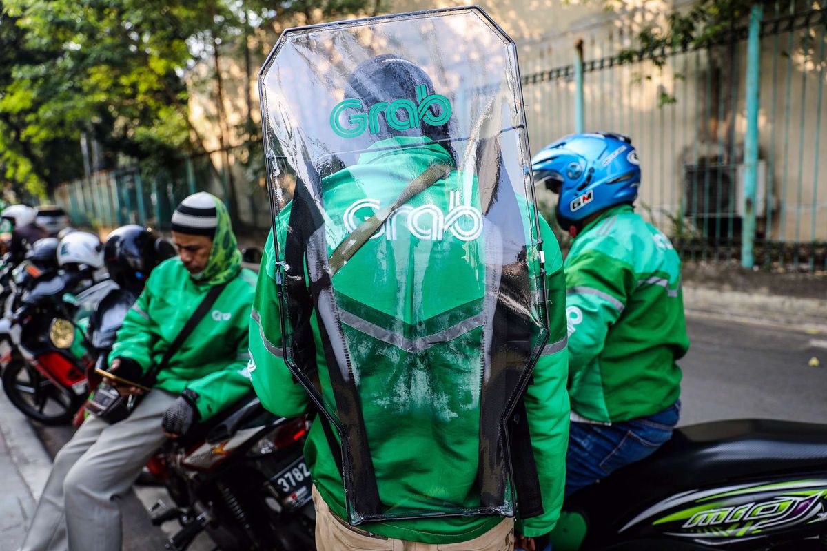 Pengemudi ojek daring mengenakan sekat pelindung saat menunggu penumpang di Jl. Kendal, Jakarta Pusat, Kamis (11/6/2020). Penggunaan sekat pelindung untuk pembatasan antara pengemudi dan penumpang tersebut sebagai bentuk penerapan protokol kesehatan guna meminimalisir risiko penyebaran virus COVID-19 dalam menghadapi era normal baru.