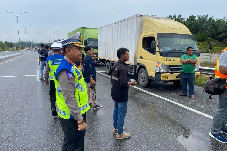 Petugas Ditlantas Polda Riau bersama pihak Hutama Karya saat mengoperasikan alat pendeteksi ODOL di pintu masuk tol Pekanbaru-Dumai, Riau, Selasa (14/11/2023).