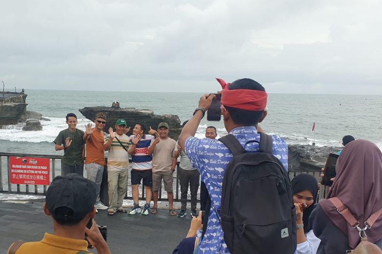 Seorang Tour Leader dari Nakula tour dan travel mendokumentasikan anggota rombongan wisatawanya.