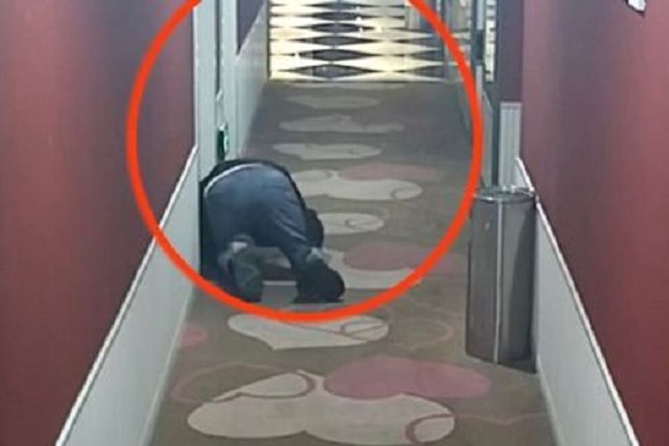 Dalam potongan rekaman kamera CCTV, seorang pria di China bernama He nampak berjongkok di depan kamar hotel dan mendengarkan pasangan berhubungan seks di dalamnya.