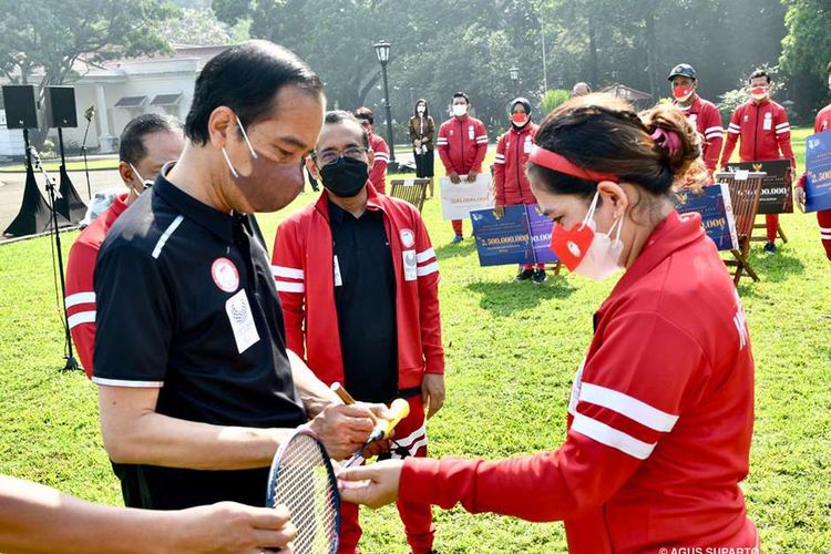 Presiden Joko Widodo menandatangani raket milik atlet bulu tangkis Leani Ratri Oktila, peraih medali emas ajang Paralimpiade Tokyo 2020, di halaman belakang Istana Kepresidenan Bogor, Jawa Barat, Jumat (17/9/2021). Presiden Joko Widodo menerima kontingan Paralimpiade Tokyo 2020 di Istana Kepresidenan Bogor sekaligus menyampaikan apresiasi dan memberikan bonus kepada atlet dan pelatih yang berlaga di ajang olahraga tersebut.