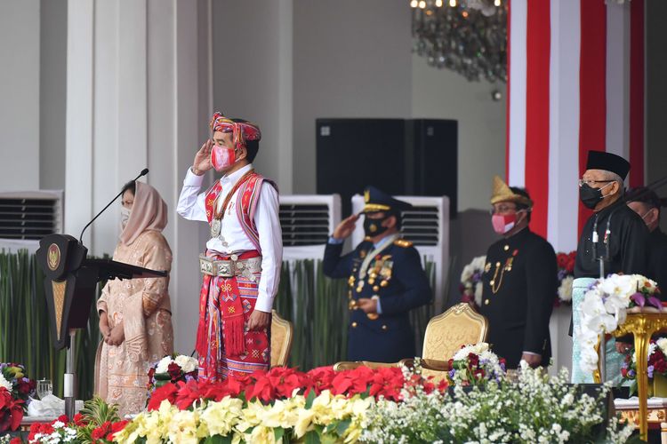 President Joko Widodo (front-right), who is accompanied by First Lady Iriana (left) and Vice President Maruf Amin attend the ceremony of the 75th Indonesia independence day in Merdeka Palace on August 17, 2020. 
