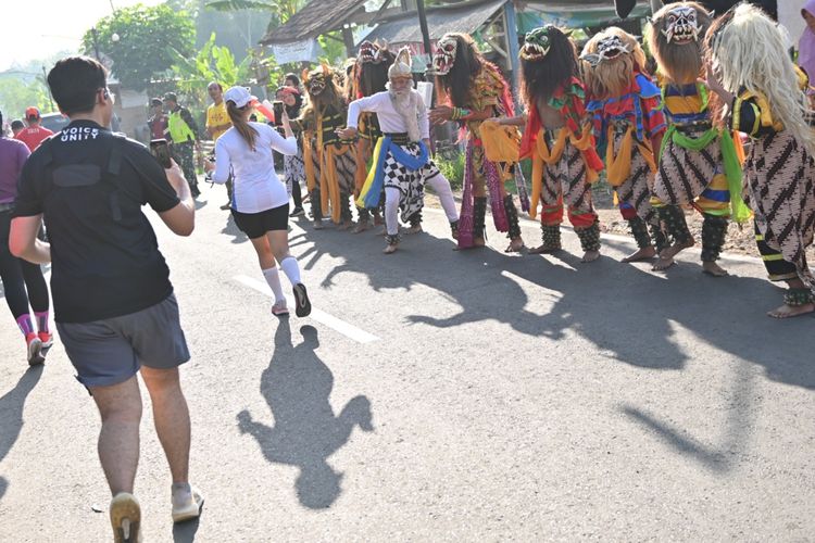 Atraksi seni tradisional yang ditampilkan warga sekitar Kawasan Candi Boroburu menyemangati pelari Borobudur Marathon 2023, Minggu (19/11/2023).