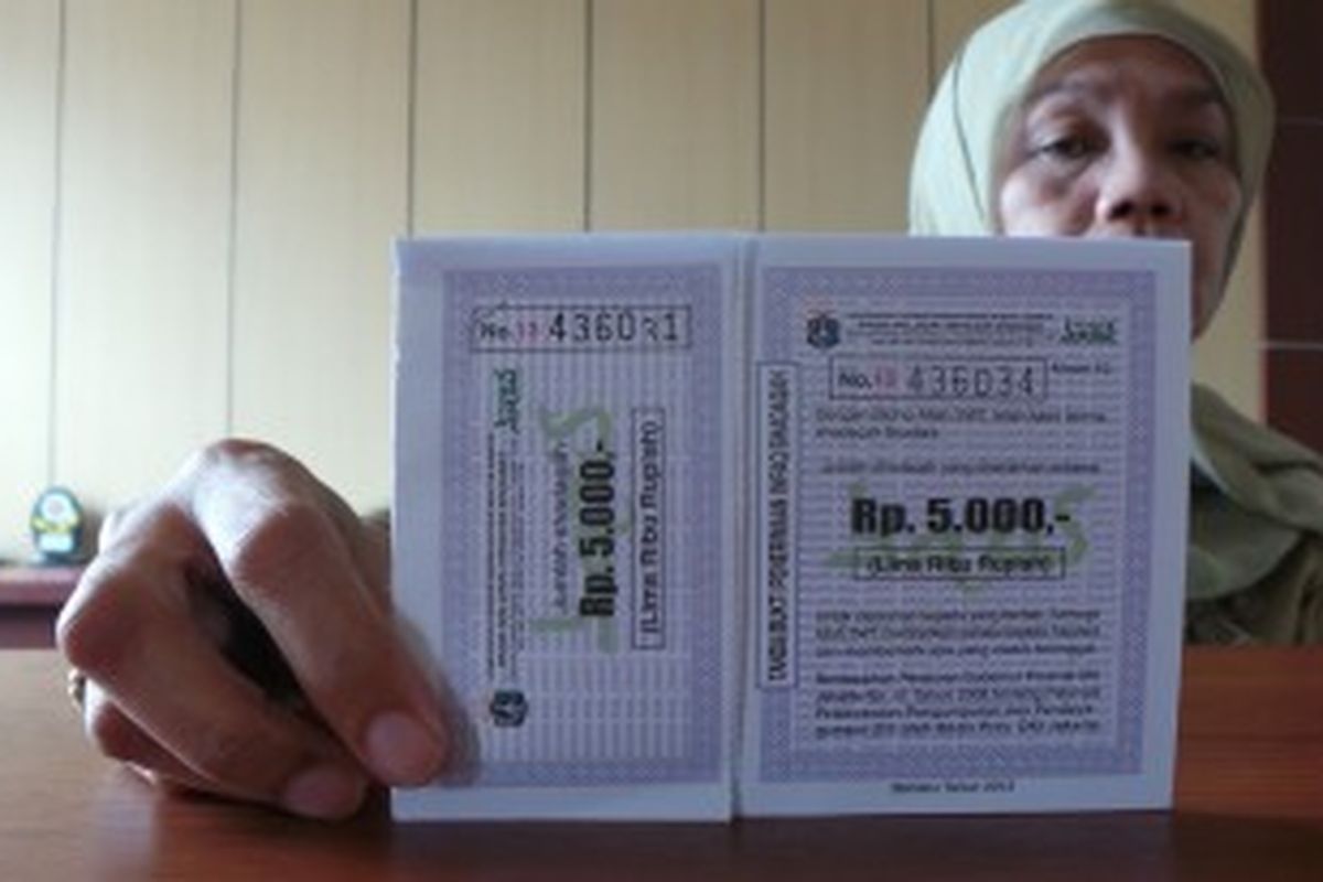 Kepala Seksi Pelayanan Kelurahan Cililitan, Ana, menunjukan kupon amal bagi warga yang mau memberikan sodakoh. Rabu (26/6/2013).