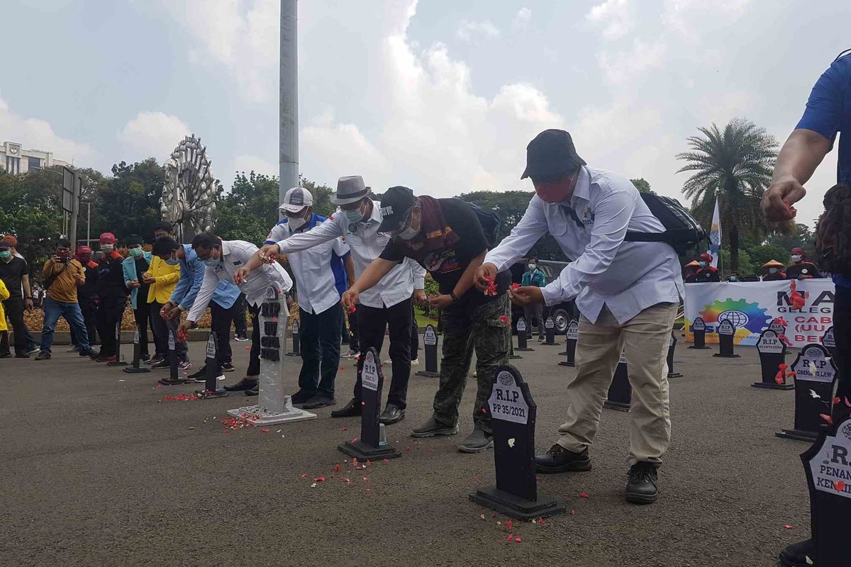 Aksi 'Kubur Omnibus Law' oleh buruh di sekitar kawasan Patung Kuda, Jakarta, pada aksi Hari Buruh (1/5/2021).