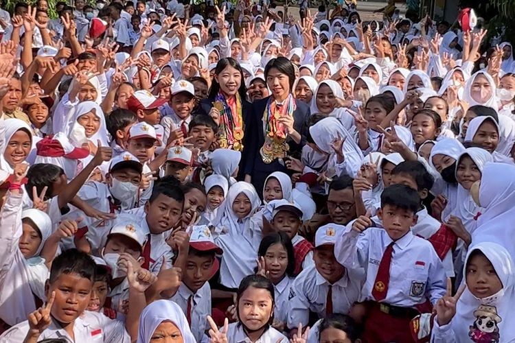 Mischka Aoki dan Devon Kei merayakan keberhasilan meraih medali ke-100 dari olimpiade matematika dan sains bersama 1.000 pelajar lewat road to schooll mereka ke Jawa Timur.
