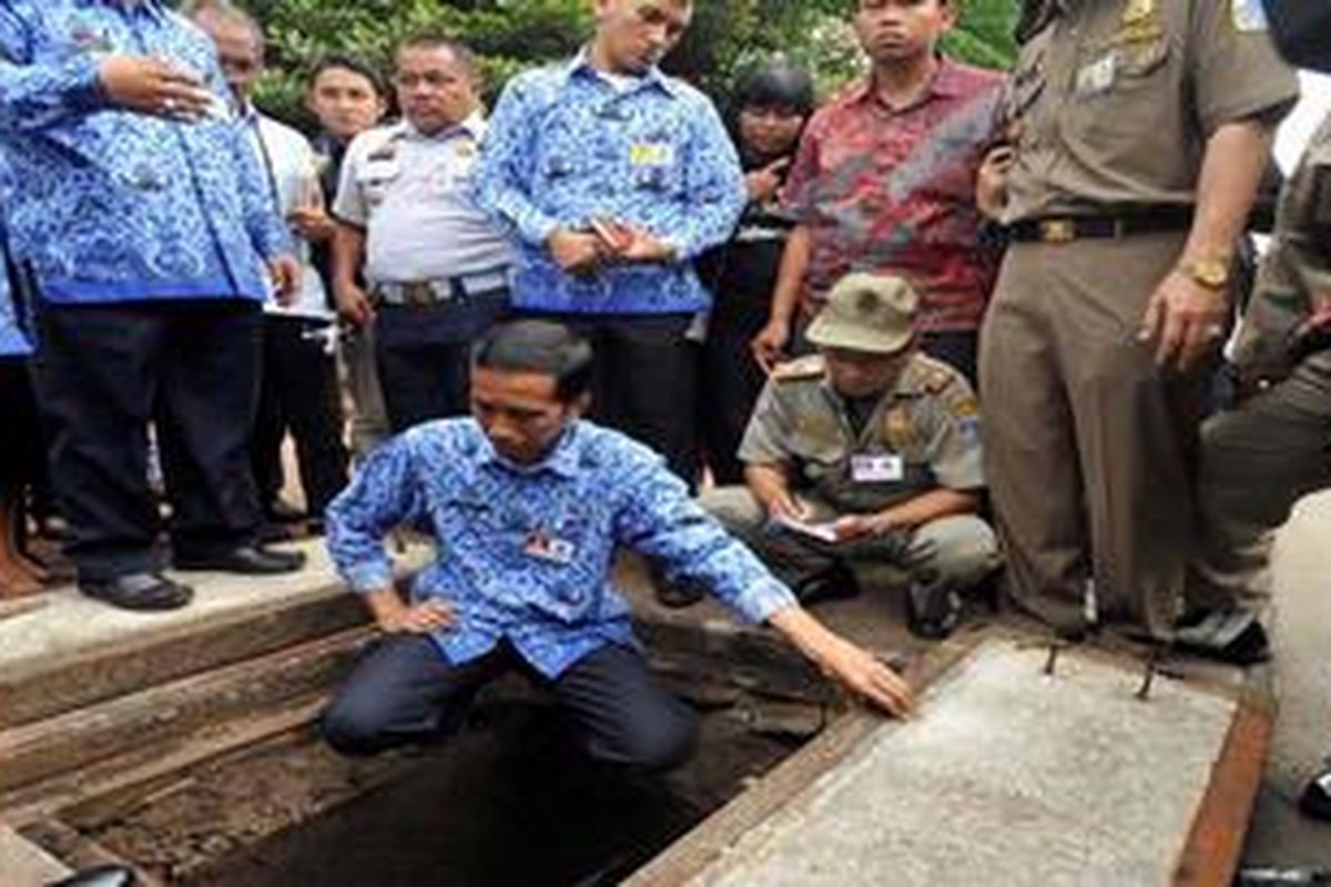 Gubernur DKI Jakarta, Joko Widodo, memeriksa gorong-gorong saluran pembuangan Jalan MH THamrin di sekitar Bundaran Hotel Indonesia, Jakarta, Rabu (26/12/2012). Pemeriksaan ini untuk melihat langsung kondisi saluran pembuangan yang diduga tersumbat dan menjadi penyebab timbulnya genangan saat hujan deras.

