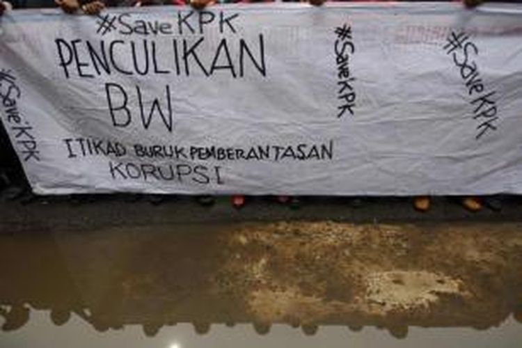 Buruh membawa sepanduk saat berunjuk rasa di depan gedung Komisi Pemberantasan Korupsi, Jakarta, Jumat (23/1/2015). Aksi ini merupakan respons atas penangkapan Wakil Ketua KPK Bambang Widjojanto, oleh Bareskrim Mabes Polri.