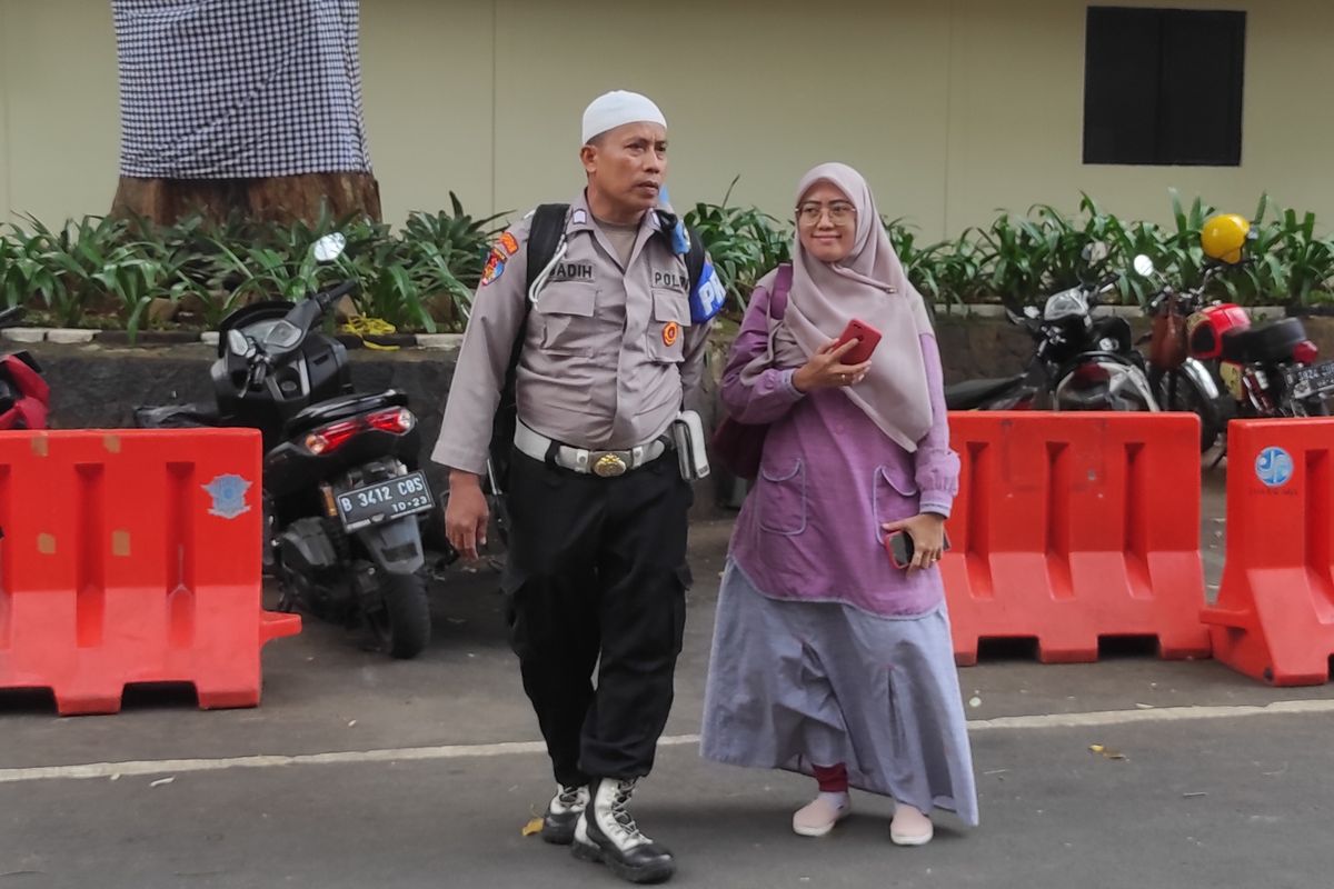 Bripka Madih ditemani sang istri saat menyambangi Polda Metro Jaya untuk klarifikasi kasus penyerobotan tanah yang menimpa dirinya, Minggu (5/2/2023). 