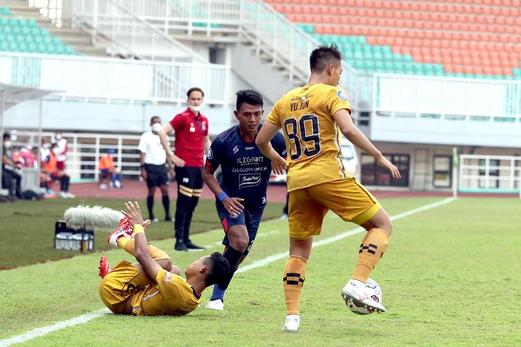 Pemain Arema FC Dedik Setiawan dijaga ketat pemain Bhayangkara FC pada laga pekan 2 Liga 1 2021-2022 yang berakhir dengan skor 1-1 di Stadion Pakansari Bogor, Minggu (12/9/2021) sore.