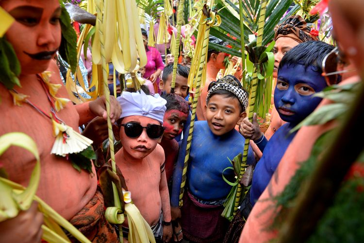 Sejumlah anak mengenakan riasan warna-warni saat mengikuti ritual Ngerebeg di Desa Tegallalang, Gianyar, Bali, Rabu (6/9/2023). Tradisi berkeliling kampung oleh ratusan warga setempat yang merias tubuhnya menyerupai makhluk menyeramkan tersebut dilakukan untuk menciptakan keharmonisan antar-makhluk Tuhan, menetralisir energi negatif serta untuk menolak bala. ANTARA FOTO/Fikri Yusuf/nz
