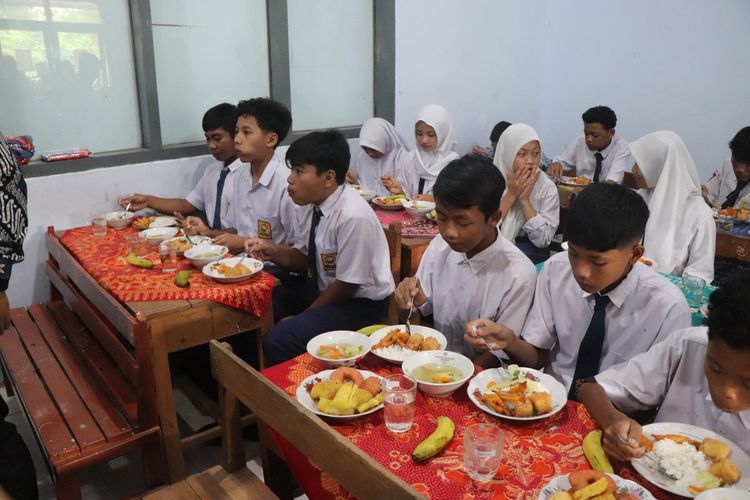 Para siswa di Kecamatan Suruh Trenggalek Jawa Timur, menikmati program makan bergizi gratis menggunakan tempat makan yang dibawa dari rumah masing-masing, Kamis (30/01/2025).