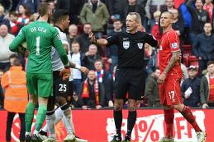 Kiper Manchester United (MU), David De Gea (kiri) dan bek Liverpool, Martin Skrtel (kanan) di sela-sela laga lanjutan Premier League di Anfield, Minggu (22/3/2015). 