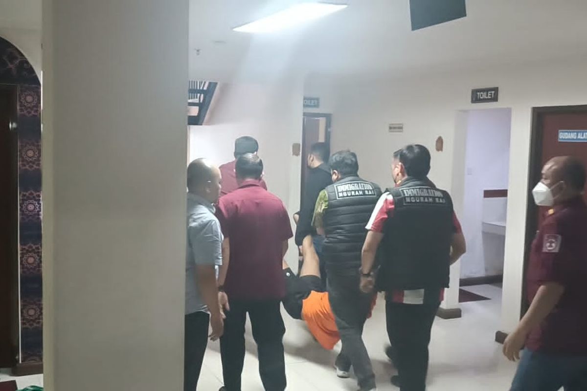 AF (34), saat digotong petugas lantaran mengamuk saat hendak dihadirkan dalam konferensi di di Kantor Imigrasi Kelas I TPI Ngurah Rai, Kabupaten Badung, Provinsi Bali, pada Kamis (15/8/2024). Kompas.com/ Yohanes Valdi Seriang Ginta