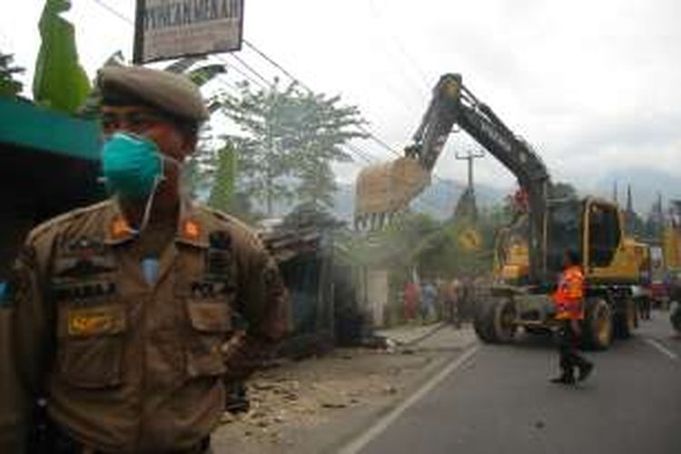 Petugas Satpol PP Kabupaten Bogor membongkar bangunan liar tanpa izin di simpang Taman Safari Indonesia, Puncak, Bogor, Jawa Barat, Senin (22/8/2016).