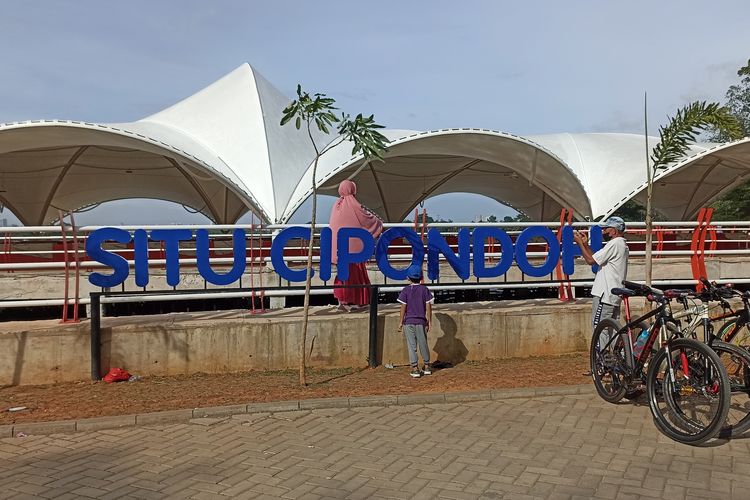 Pengunjung Situ Cipondoh di Kota Tangerang, Banten, yang tengah berfoto, Senin (16/1/2023).