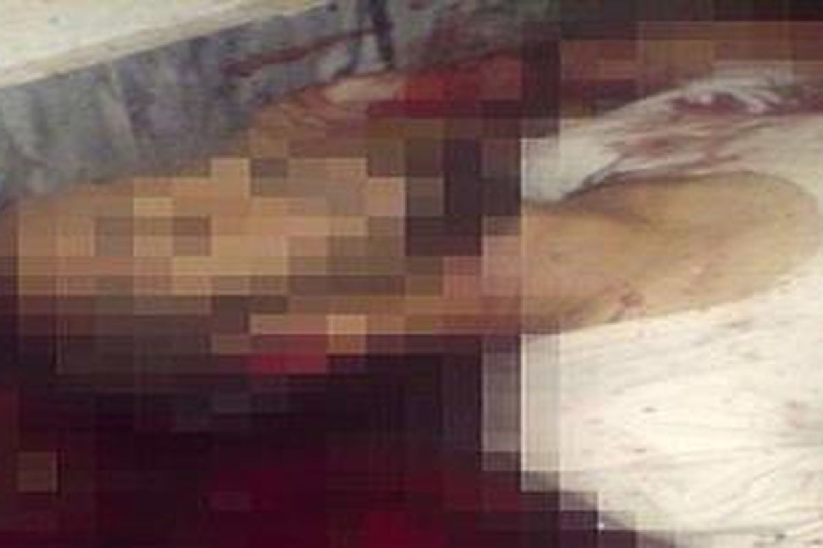 Dead: A third man is seen lying in a pool of blood after a U.S. raid on Osama Bin Ladens compound   