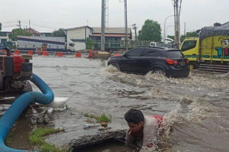 Petugas penjaga pompa air di Jalan Kaligawe-Genuk, Kota Semarang, Jawa Tengah masih berjibaku menangani banjir. 