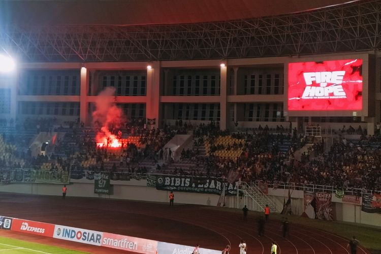 Oknum suporter menyelamatkan flare di Tirbun Stadion Manahan, Kota Solo, Jawa Tengah (Jateng) setelah laga pra-musim Persis Solo vs Persebaya Surabaya usai, pada Sabtu (24/6/2023).