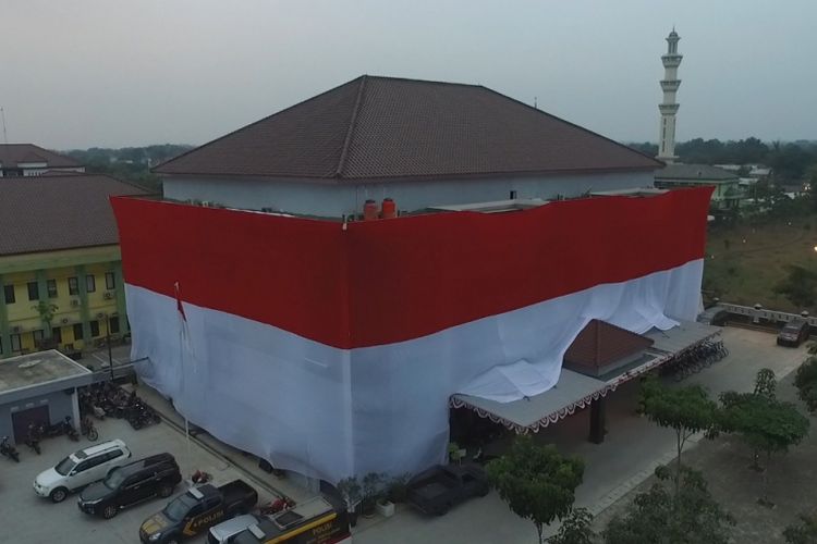 Gedung Polres Kota Tangerang diselimuti bendera merah putih dan meraih penghargaan Pembentang Bendera Merah Putih Terbesar se-Indonesia dengan panjang 135 x 13 meter dari Lembaga Prestasi Indonesia Dunia (Leprid) pada Senin (14/8/2018).  