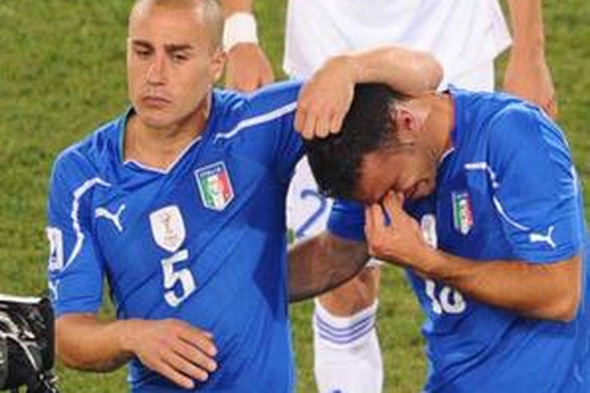 Kapten Italia, Fabio Cannavaro (kiri), menghibur Fabio Quagliarella, yang menangis setelah Italia tersingkir dari penyisihan grup Piala Dunia 2010.