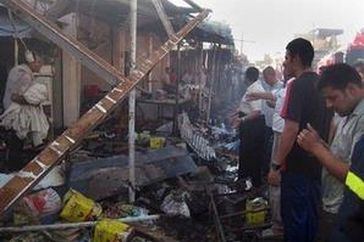 Sejumlah warga berkumpul di lokasi serangan bom mobil di Kirkuk, Irak, 30 Juni 2009 