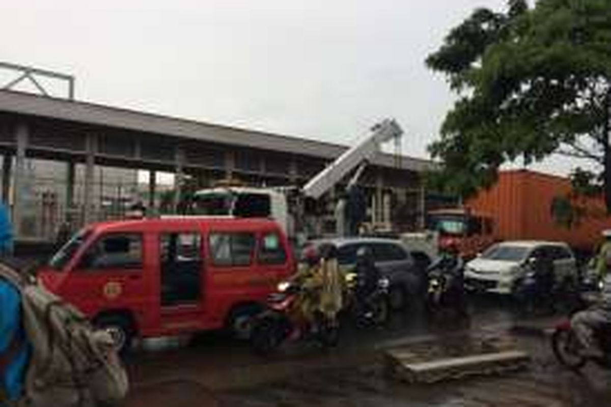 Petugas mengevakuasi truk kontainer yang menabrak separator busway di dekat Halte Transjakarta Sumur Bor, Jakarta Barat, Minggu (13/11/2016).