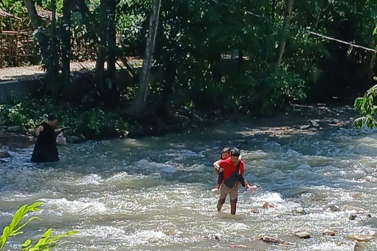 Jembatan Penghubung Bogor-Karawang Putus, Siswa Seberangi Sungai ke Sekolah  Digendong Orangtuanya