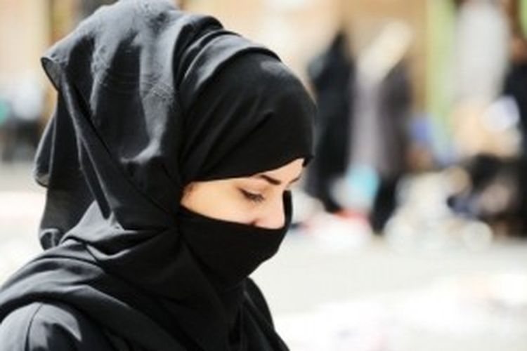 Perempuan Muslim dengan burqa yang menutup rapat tubuhnya.
