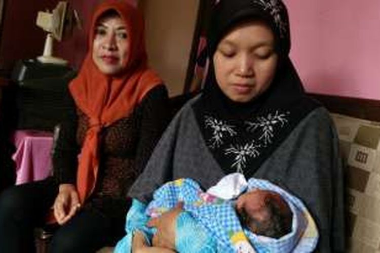 Dwi Agustin Andarini (kanan), Selasa (26/7/2016), menggendong bayinya yang lahir di atas kereta api Probowangi jurusan Banyuwangi-Surabaya Senin sehari sebelumnya.