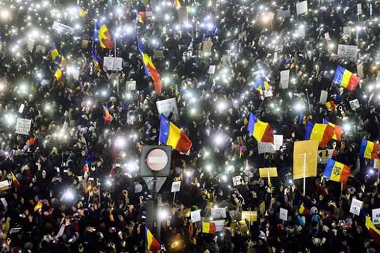 Demonstran di Bukares, Rumania, beramai-ramai menyalakan layar smartphone mereka, Minggu (5/2/2017) malam. 