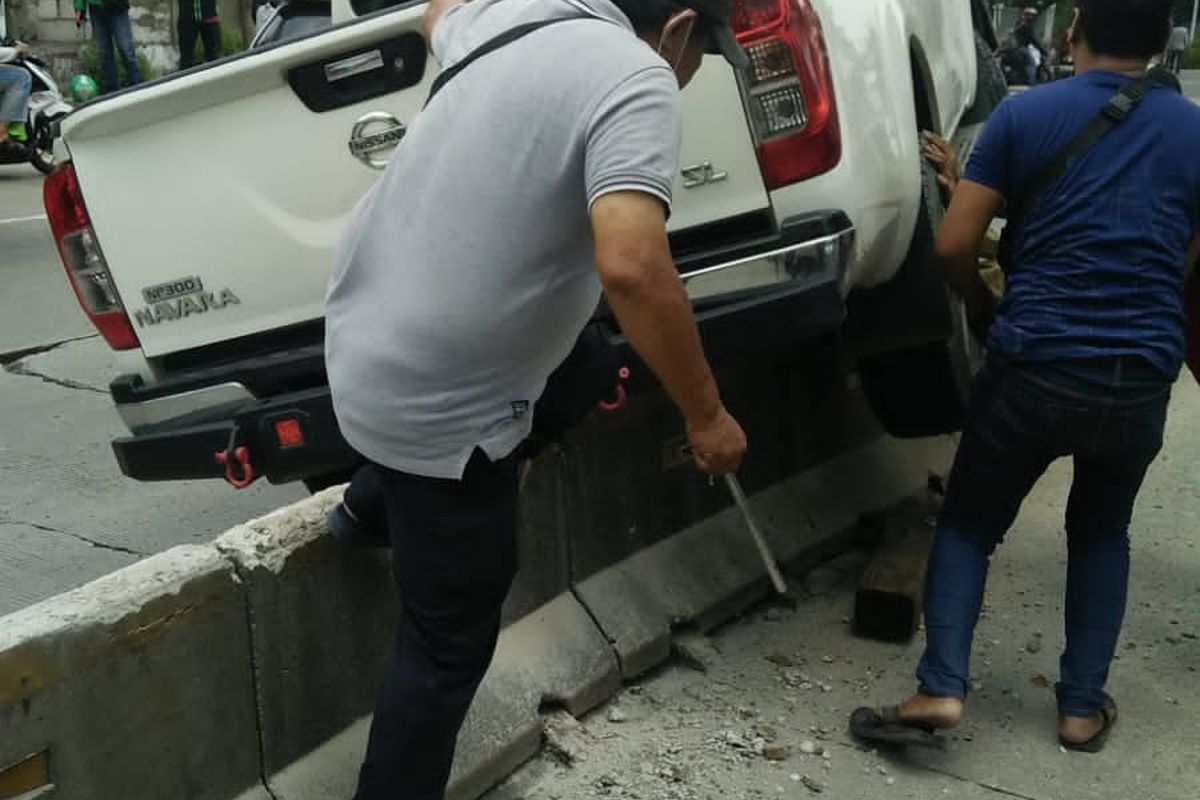 Mobil Nissan Navara bernomor polisi BA 8126 LQ tersangkut di separator busway di Jalan Daan Mogot, Tanjung Duren, Jakarta Barat, Minggu (3/10/2021).