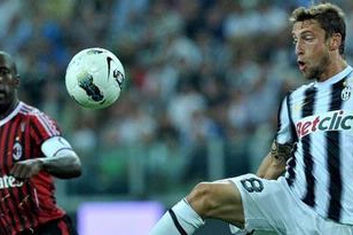 Gelandang Juventus, Claudio Marchisio, dikawal kapten AC Milan, Clarence Seedorf, pada pertandingan Liga Serie-A, Minggu atau Senin (3/10/2011) dini hari WIB. Marchisio mencetak dua gol dan membuat Juventus menang 2-0.