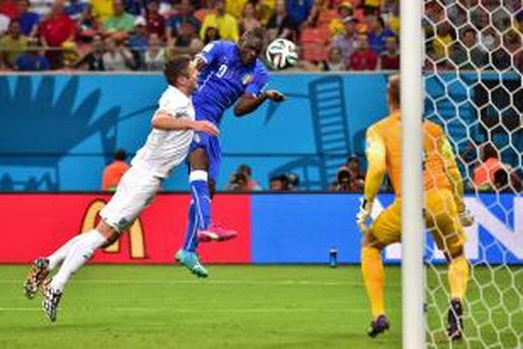 Striker Italia, Mario Balotelli, saat menyundul bola yang berujung gol ke gawang Inggris pada pertandingan Grup D Piala Dunia 2014 di Arena Amazonia, Manaus, Minggu (15/6/2014) pagi WIB. Italia menang 2-1 pada pertandingan tersebut. 