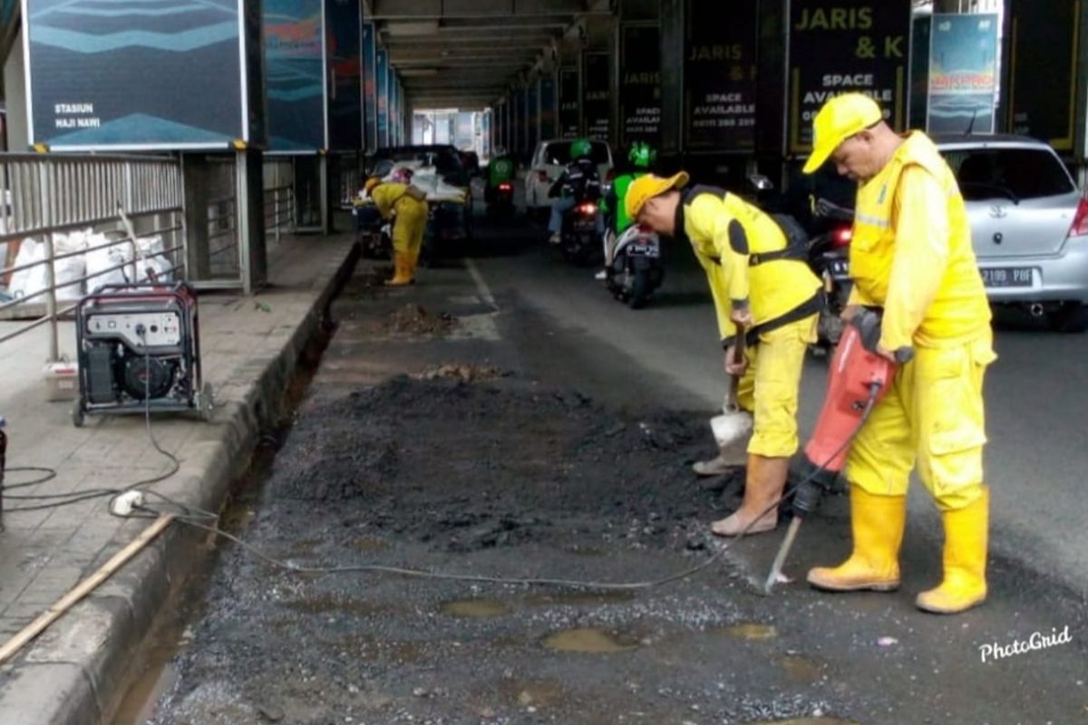 Petugas dari Sudin Bina Marga Jakarta Selatan sedang memperbaiki jalan rusak di Jalan RS Fatmawati tepatnya di bawah Stasiun MRT Haji Nawi, Cilandak, Jakarta Selatan.