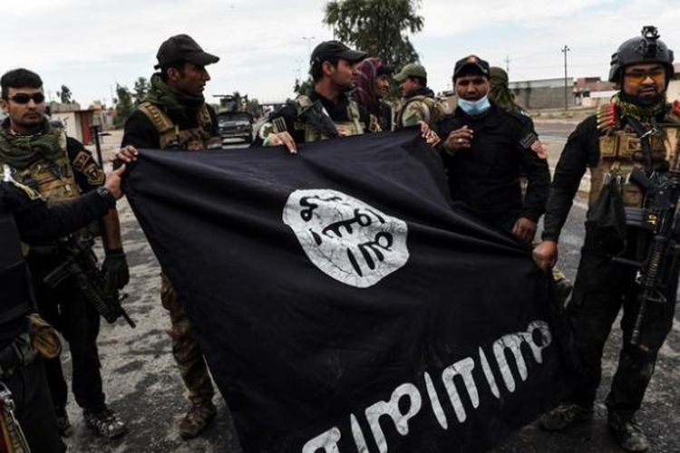 Tentara Irak memperlihatkan bendera ISIS yang diperoleh setelah mereka merebut pertahanan ISIS di sebuah desa di sisi timur kota Mosul.