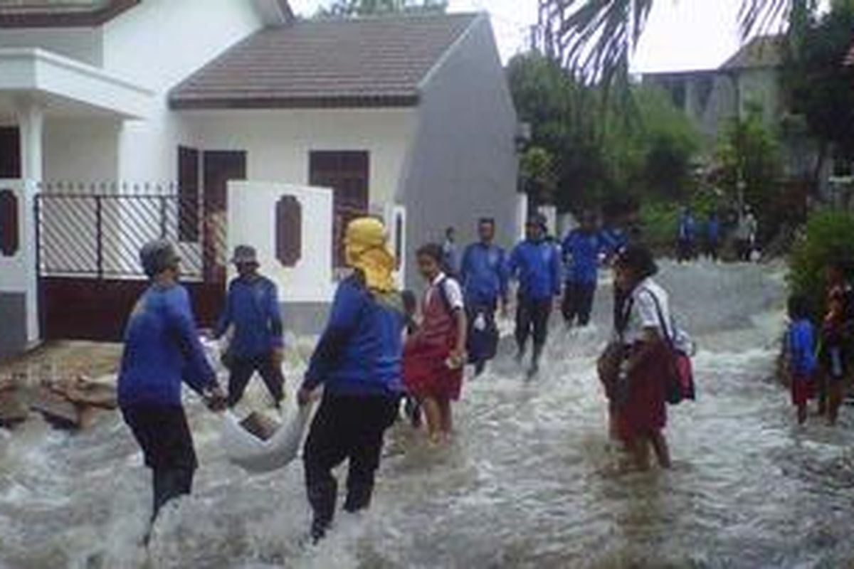 Satgas Banjir Bimasda Depok tengah mengangkut material melewati derasnya air untuk menutup tanggul Kali Laya, Tugu, Depok, yang jebol, Selasa (13/11/2012). Puluhan rumah di Perum Bukit Cengkeh kebanjiran. Tidak ada korban jiwa dalam peristiwa yang terjadi dini hari tadi. 
