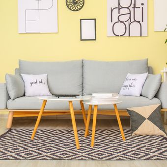 Ilustrasi ruang keluarga dengan nuansa warna kuning, ilustrasi meja nesting di ruang keluarga. 