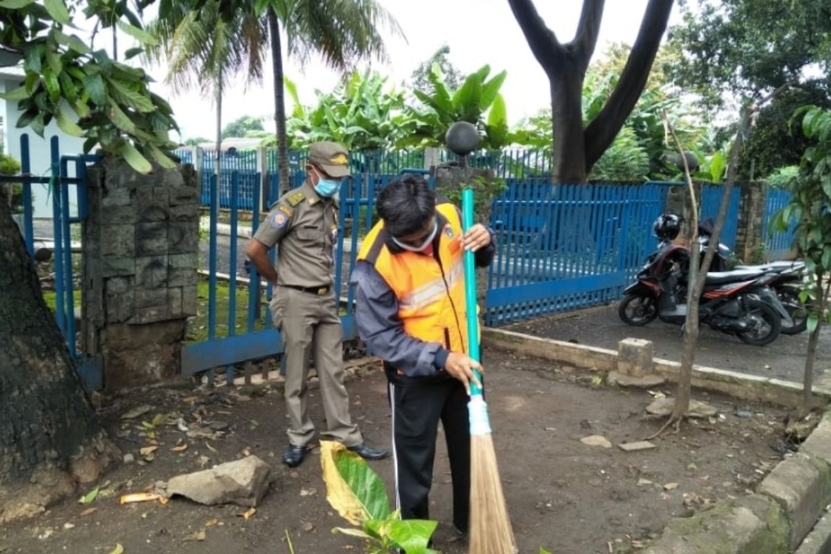 Pelanggar PSBB di Jalan Raya Bogor, Kelurahan Rambutan, Ciracas, Jakarta Timur dihukum sapu jalan, Selasa (19/5/2020).