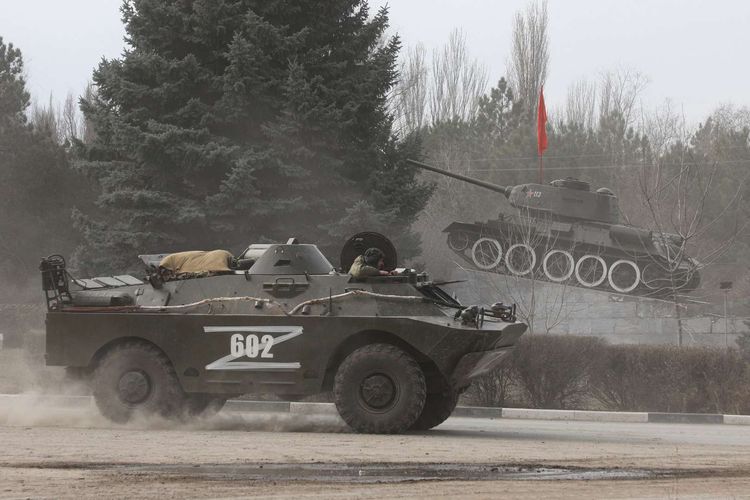 Kendaraan lapis baja dengan huruf 'Z' berjalan melewati monumen tank zaman Soviet, setelah Presiden Rusia Vladimir Putin mengesahkan operasi militer di wilayah timur Ukraina, kota Armyansk, Crimea, Kamis (24/2/2022).