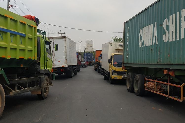 Sejumlah truk melintasi Jalan Raya Narogong-Siliwangi di Kecamatan Rawalumbu, Bekasi.