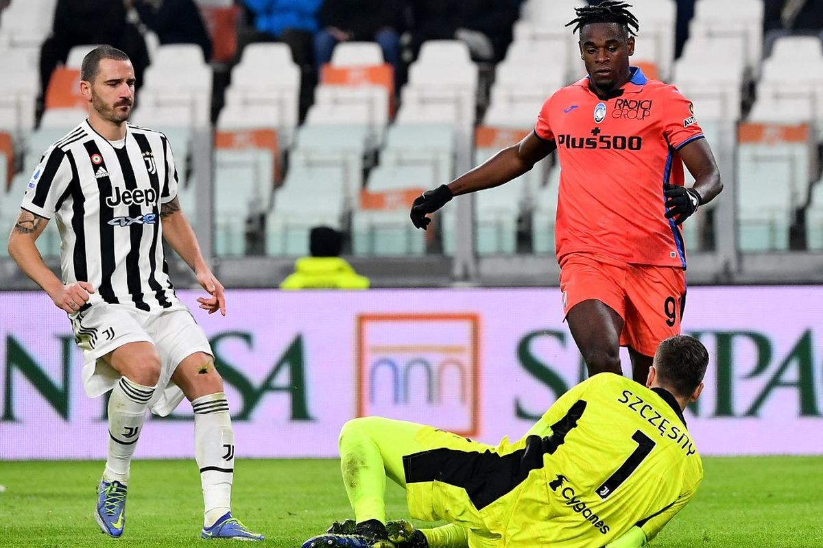 Penyerang Atalanta Duvan Zapata (kanan) berebut bola dengan kiper Juventus Wojciech Szczesny pada laga pekan ke-14 Liga Italia 2021-2022 di Stadion Allianz, Turin, Sabtu (28/11/2021) dini hari WIB.