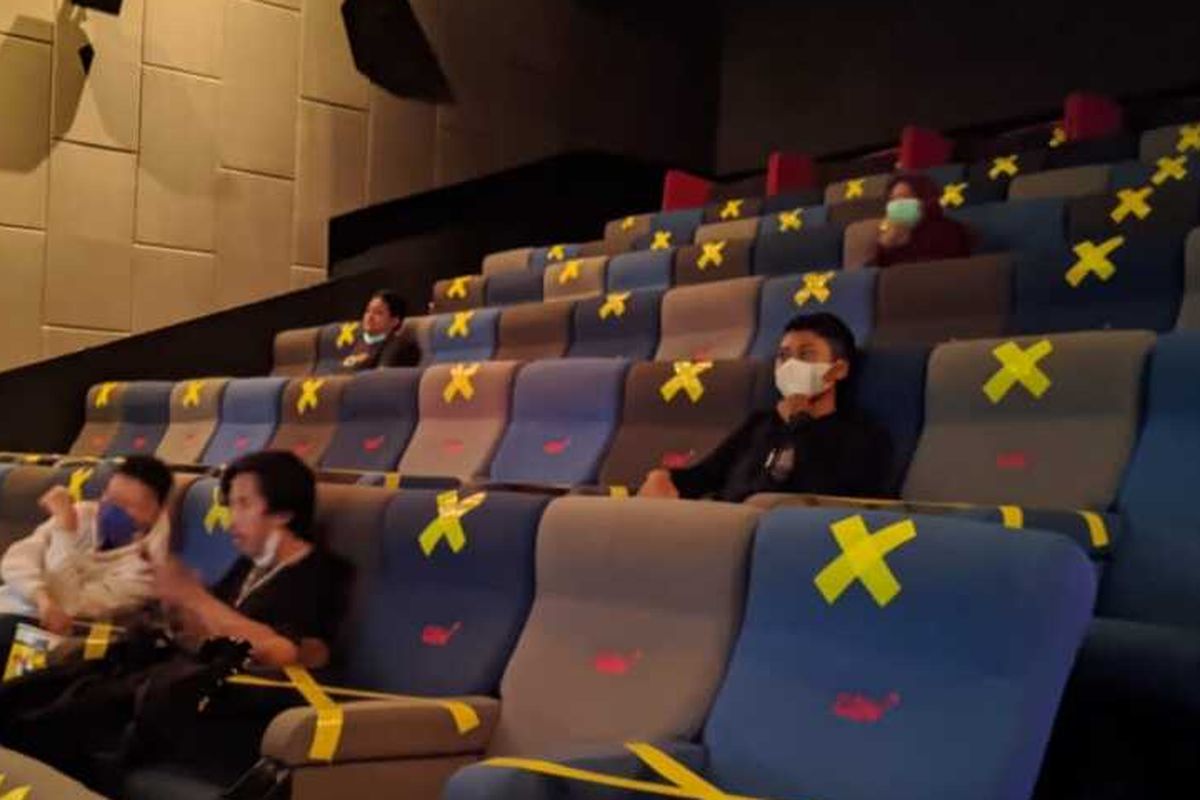 An Indonesian movie theater in Central Java follows the Covid-19 health protocols by using social distancing stickers. 